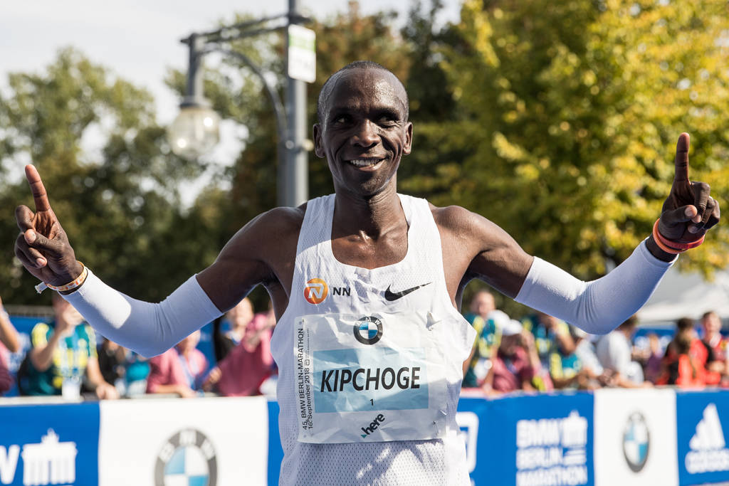 Eliud Kipchoge celebrates after breaking the world marathon record in 2018